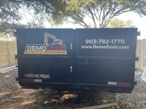 DemoGodz branded roll-off dumpster for demolition debris
